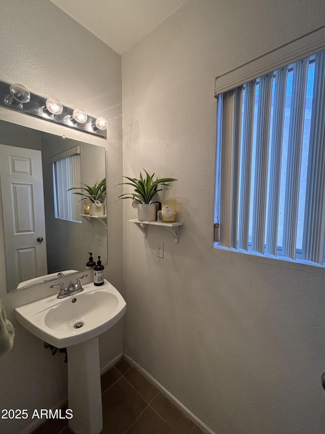 bathroom with tile patterned floors and baseboards