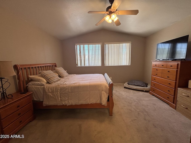 bedroom featuring carpet floors, vaulted ceiling, and ceiling fan