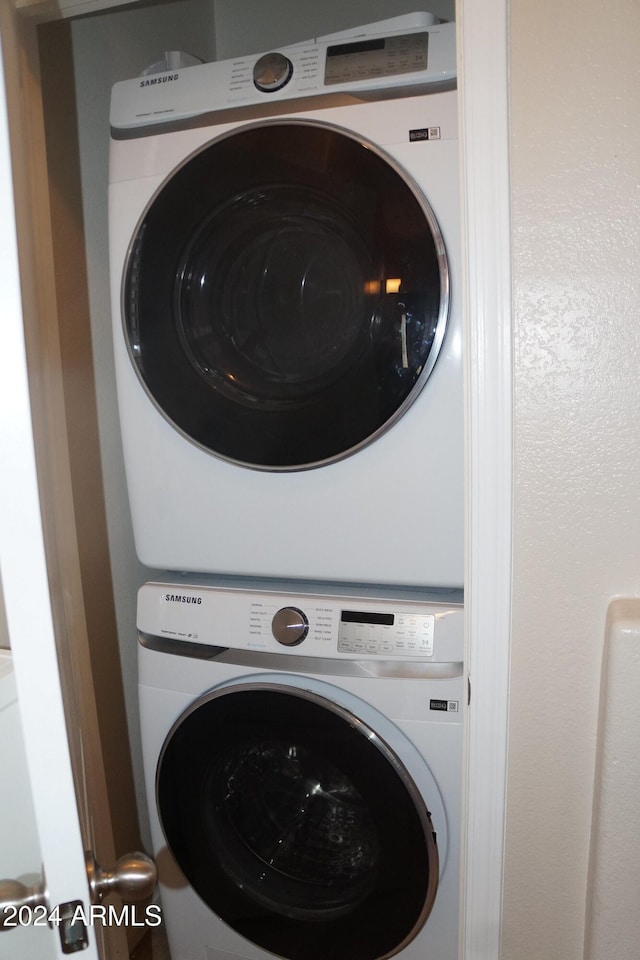 washroom with stacked washer and dryer