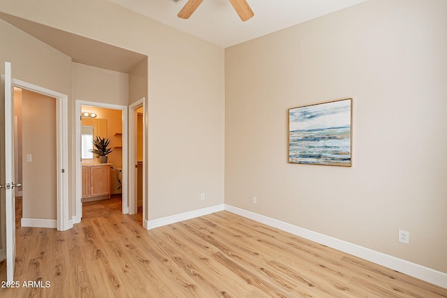 spare room with ceiling fan and light wood-type flooring