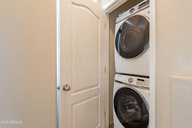 clothes washing area with stacked washer / drying machine