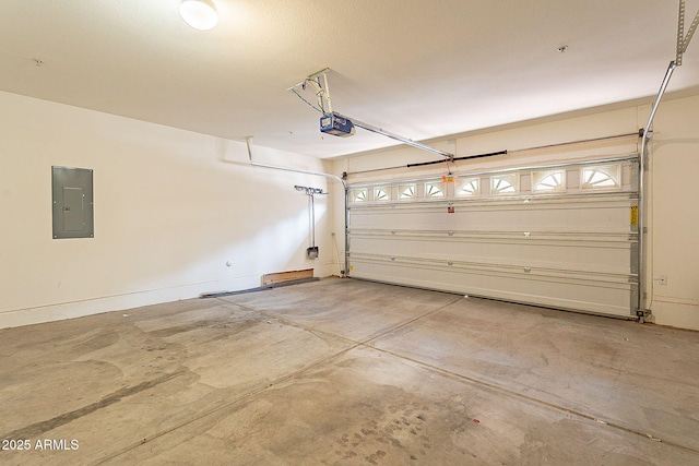 garage with a garage door opener and electric panel