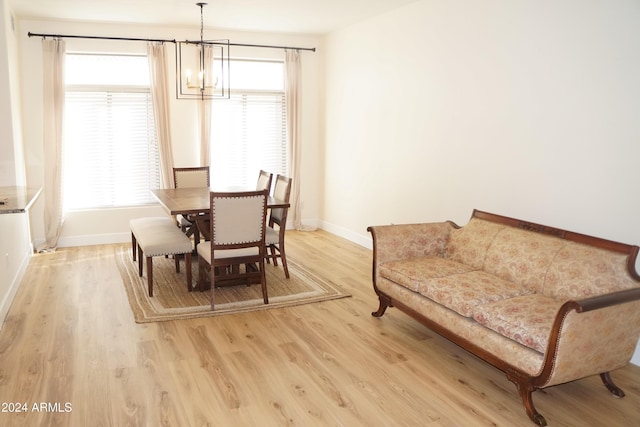 dining space with a chandelier and light wood-type flooring