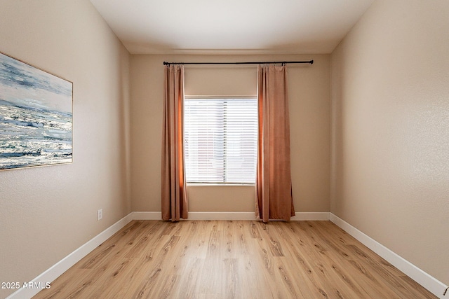 unfurnished room with light hardwood / wood-style flooring