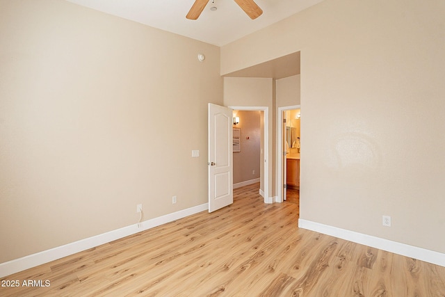 spare room with ceiling fan and light wood-type flooring