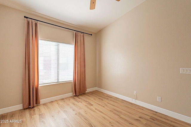 empty room with lofted ceiling, ceiling fan, and light hardwood / wood-style flooring