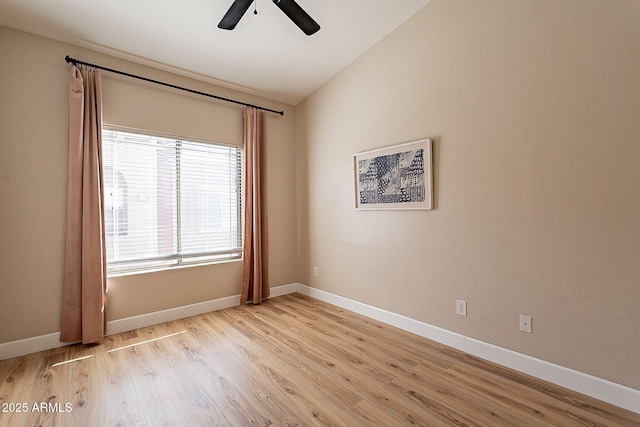 empty room with ceiling fan, lofted ceiling, and light wood-type flooring