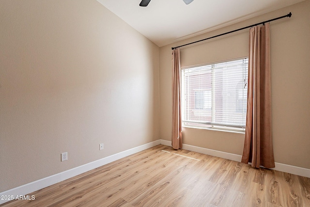 unfurnished room featuring lofted ceiling, ceiling fan, and light hardwood / wood-style flooring