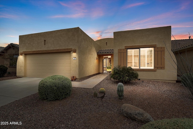 pueblo-style house featuring a garage