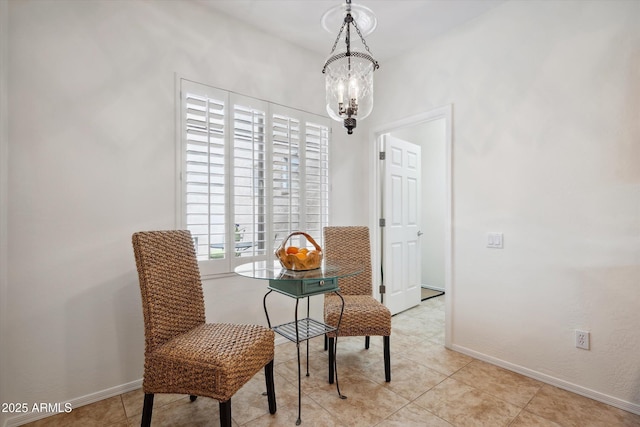 tiled dining space with a chandelier