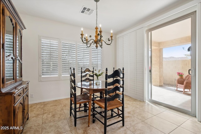 tiled dining space featuring a notable chandelier