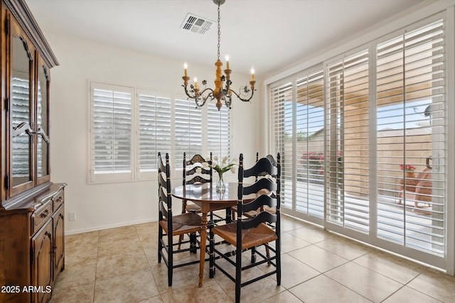 dining area featuring light tile patterned flooring and an inviting chandelier