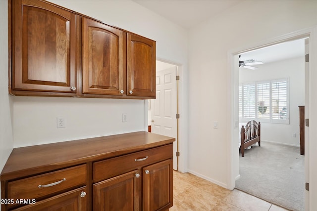 interior space with ceiling fan and light carpet