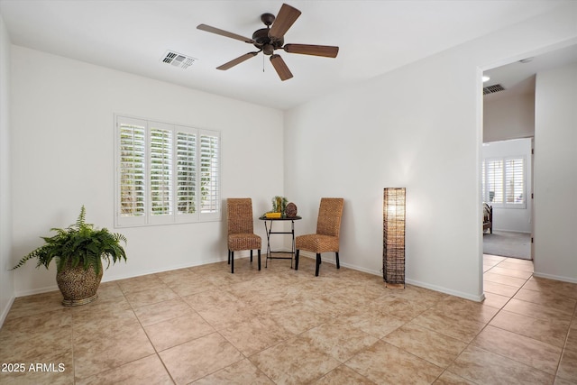 living area featuring light tile patterned flooring and ceiling fan