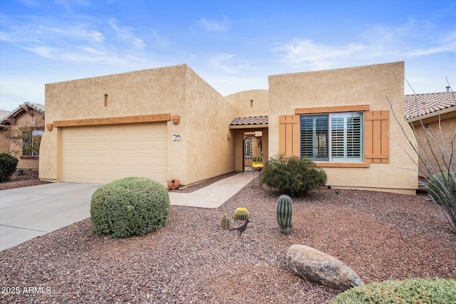 pueblo-style house featuring a garage