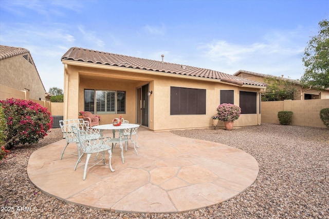 rear view of property featuring a patio area