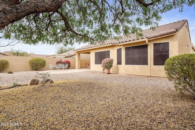 back of house with a patio