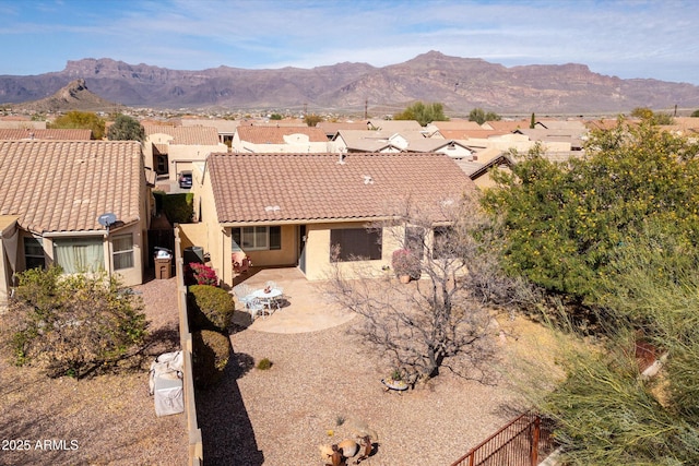 view of front of property with a mountain view and a patio