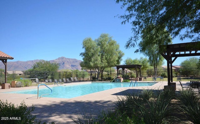 view of swimming pool featuring a mountain view and a patio area