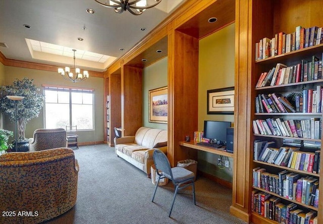 sitting room featuring crown molding, a tray ceiling, a chandelier, and carpet