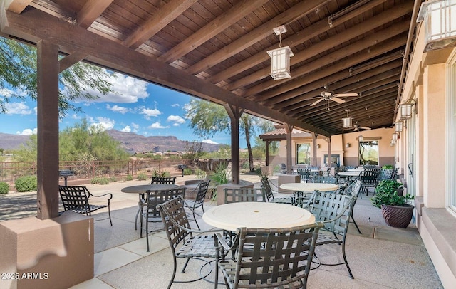 view of patio / terrace featuring a mountain view and ceiling fan