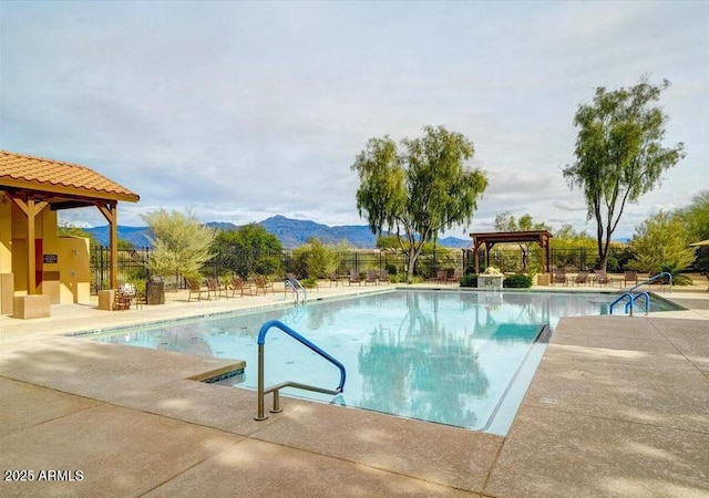 view of swimming pool featuring a mountain view and a patio