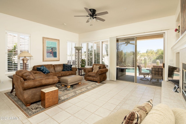 tiled living room featuring a healthy amount of sunlight and ceiling fan