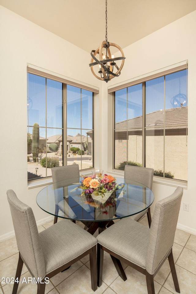 tiled dining space with a chandelier