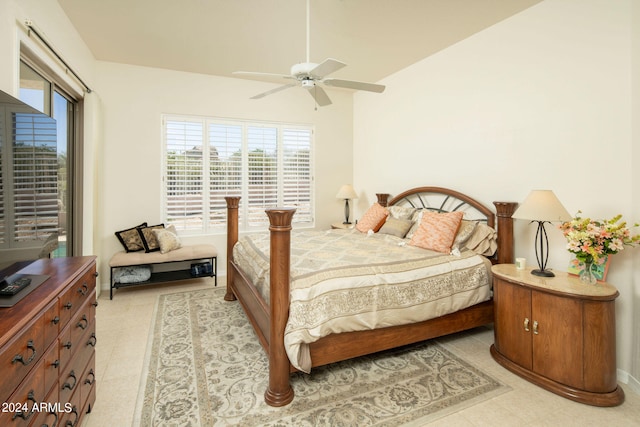 bedroom with lofted ceiling, ceiling fan, and light tile floors