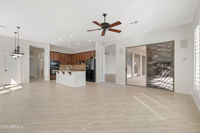 unfurnished living room featuring a sink, baseboards, visible vents, ceiling fan, and recessed lighting