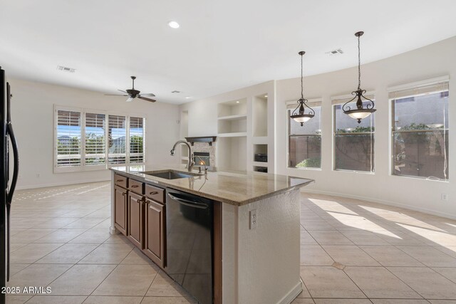 kitchen featuring light tile patterned floors, a sink, visible vents, dishwashing machine, and built in features