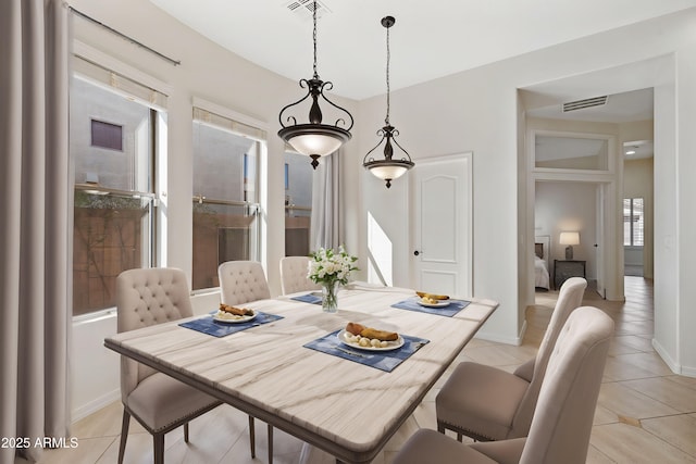 dining room with baseboards, visible vents, and light tile patterned floors