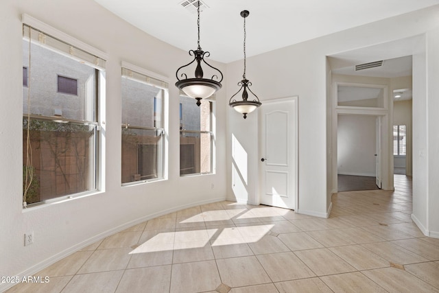 unfurnished dining area featuring tile patterned floors, visible vents, and baseboards