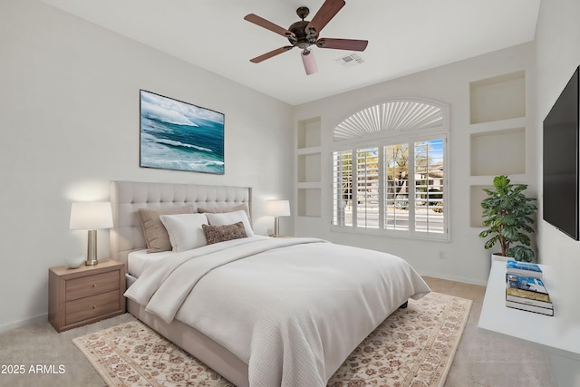 bedroom featuring a ceiling fan, light carpet, and baseboards