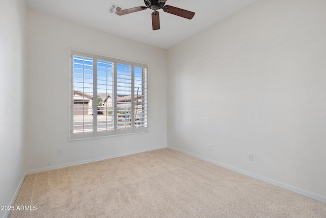 empty room with baseboards, visible vents, ceiling fan, and carpet floors