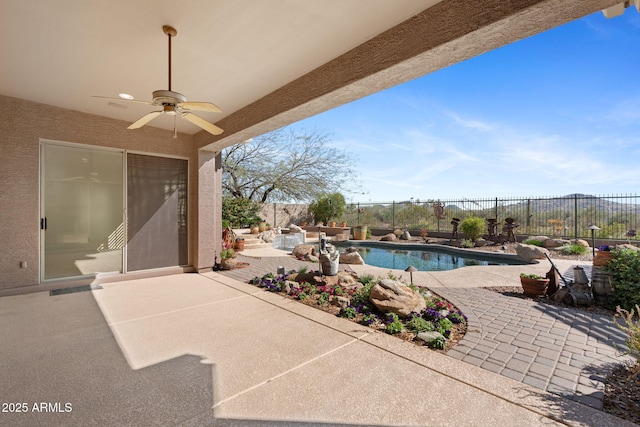 view of swimming pool featuring a fenced backyard, a ceiling fan, a fenced in pool, and a patio