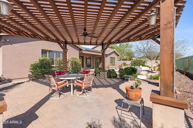 view of patio with a pergola, outdoor dining space, ceiling fan, and fence