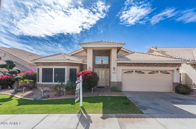 mediterranean / spanish house with a garage and a front yard