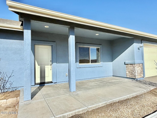 doorway to property with a garage