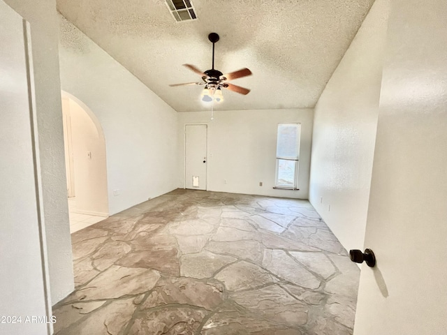 empty room with a textured ceiling and ceiling fan