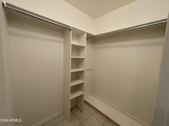 spacious closet featuring light tile patterned flooring