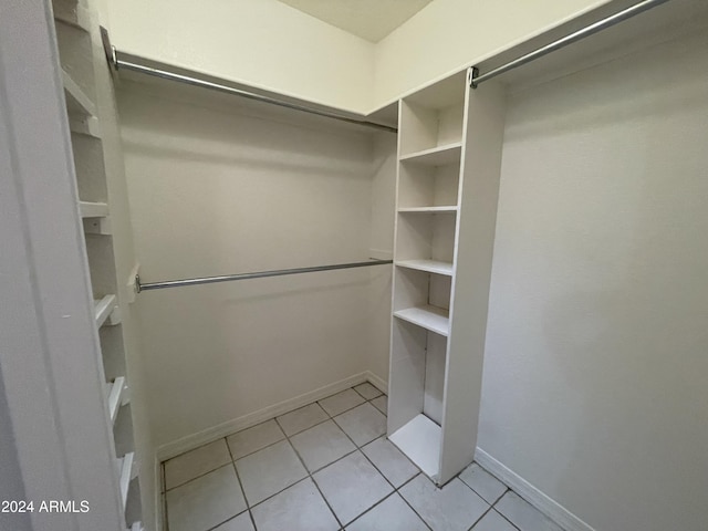 spacious closet with light tile patterned floors