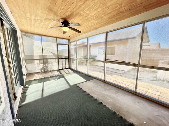 unfurnished sunroom featuring ceiling fan and wooden ceiling