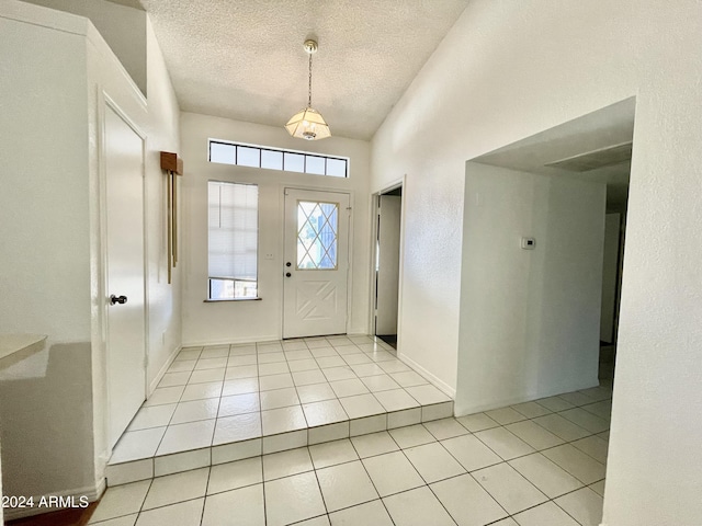 entrance foyer featuring light tile patterned flooring and a textured ceiling