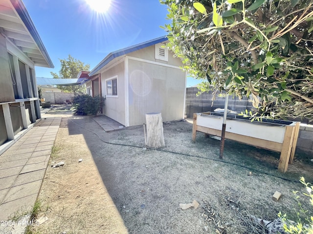 view of property exterior featuring a storage shed