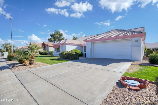 view of front of house featuring a garage and a front lawn