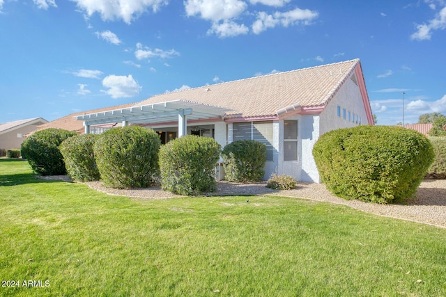 view of property exterior featuring a lawn and a pergola