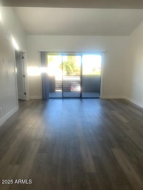 unfurnished room with dark hardwood / wood-style floors