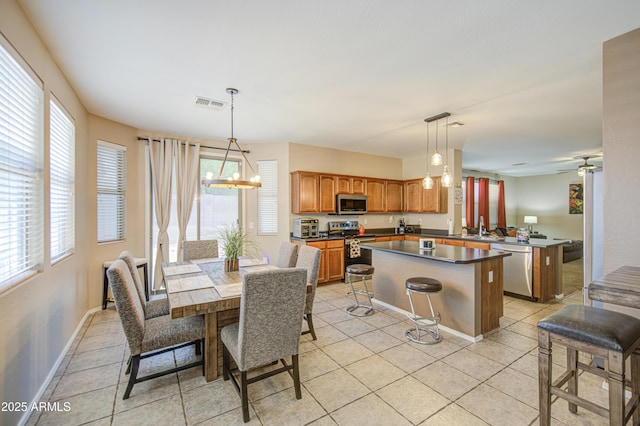 kitchen featuring a healthy amount of sunlight, stainless steel appliances, a kitchen island, and visible vents
