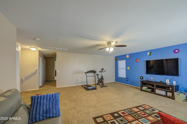 workout area with carpet, visible vents, baseboards, and a ceiling fan
